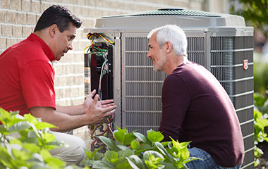 kolenda-home-cooling HVAC repair technician discussing air conditioner repair with homeowner