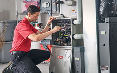 kolenda-home-heating HVAC technician repairing a furnace